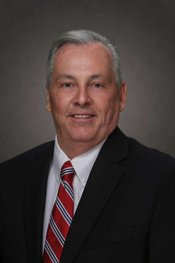 Florida Paints Welcomes Fletcher Moore as New Business Development Executive. Headshot of Fletcher Moore, Florida Paints' Business Development Executive of Commercial Development wearing black suit jacket and red tie