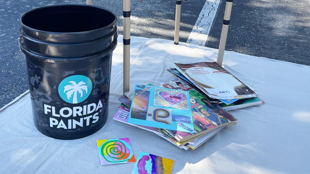 Florida Paints bucket decorated with artwork created by community members during the Paint a Brighter Day event.
